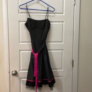 In great condition spaghetti strap, black and white polka-dot with pink trim.